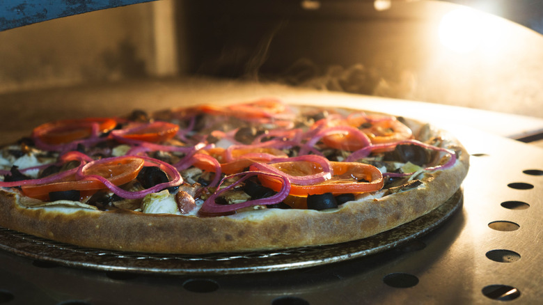 Pizza cooking on a baking steel