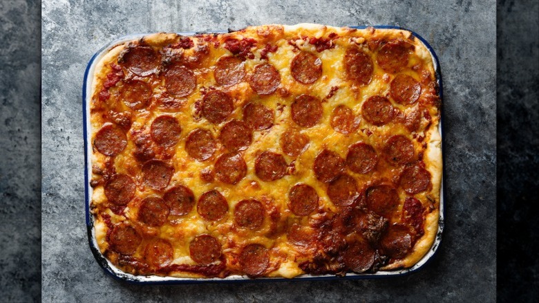 A rectangular pan of Detroit-style pizza.