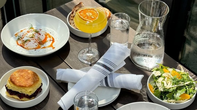 Various brunch dishes and cocktail on table at Lincoln Street Kitchen & Cocktails