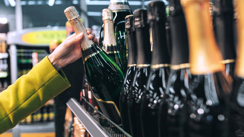 grabbing Champagne bottle