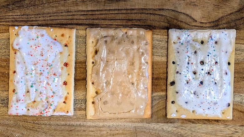 Strawberry, brown sugar, and blueberry Pop-Tarts on a wood board