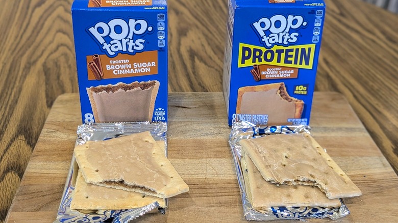 Two boxes of brown sugar Pop-Tarts and two unwrapped Pop-Tarts on a wooden table