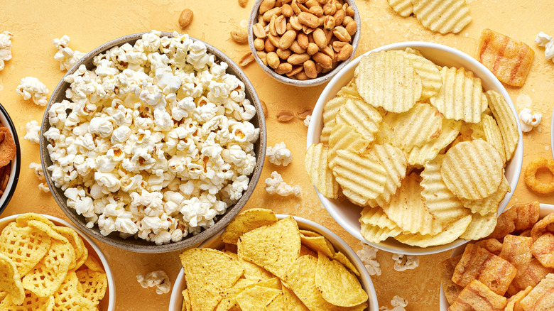 bowls of popcorn and different kinds of potato chips