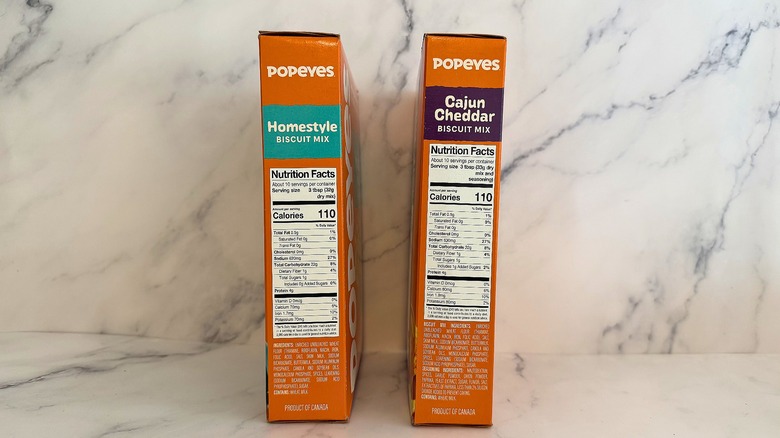 Popeyes biscuit mix boxes showing nutrition labels on marble surface