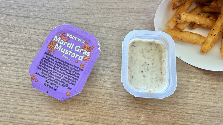Mardi Gras Mustard packet next to fries
