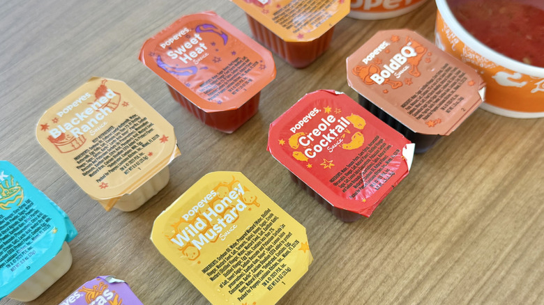View of different Popeyes sauces on table