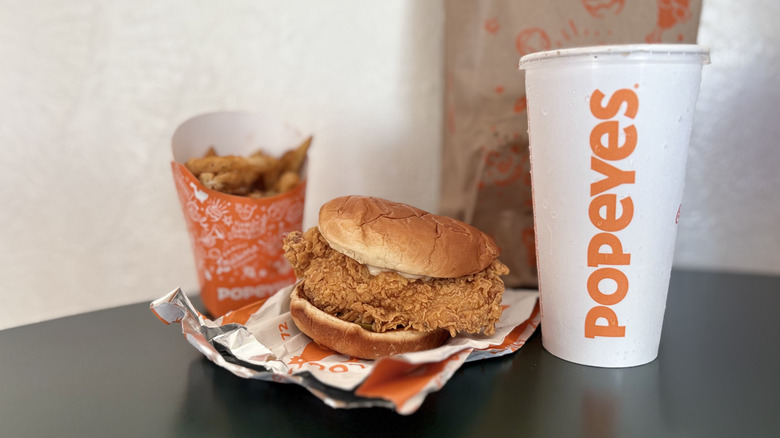 Fried chicken sandwich with orange and white packaging