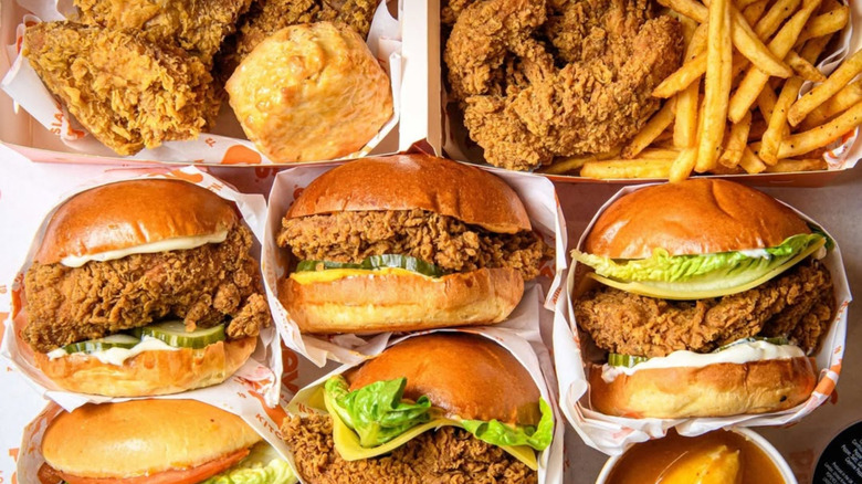 Paper takeout containers of food from Popeyes Louisiana Kitchen