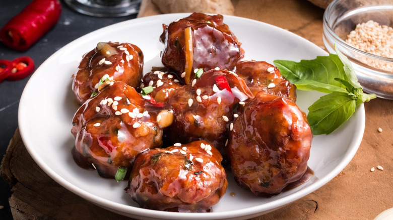 Close-up on cocktail meatballs on a white plate