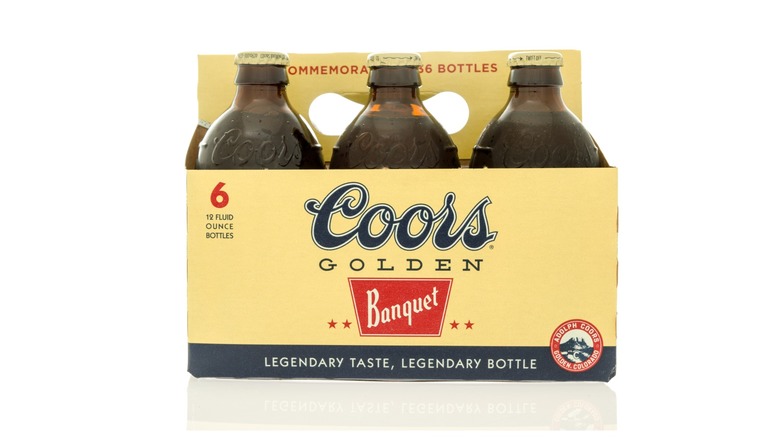 A six pack of Coors Banquet beer bottles against a white background