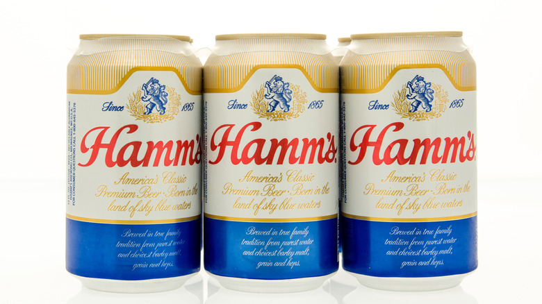 Three cans of Hamm's beer on a white background