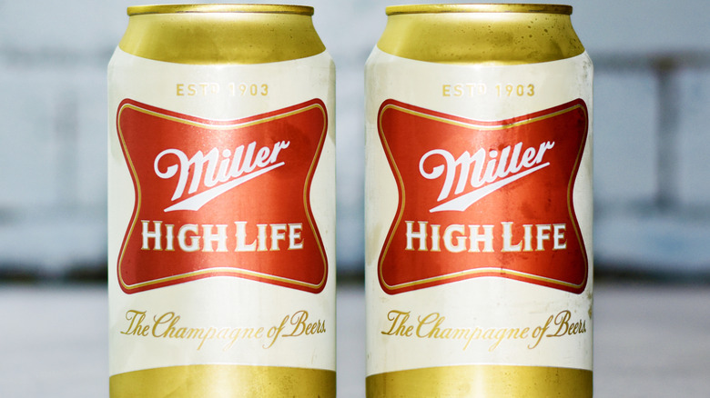 Two cans of Miller High Life beer