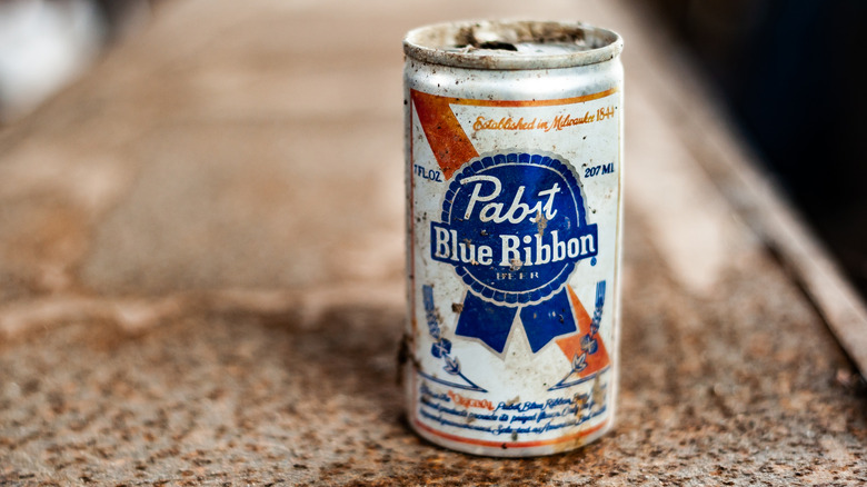 An old can of Pabst Blue Ribbon beer with rust on it