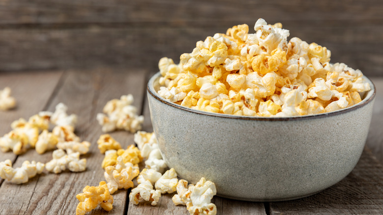 A bowl of popcorn on a wooden table