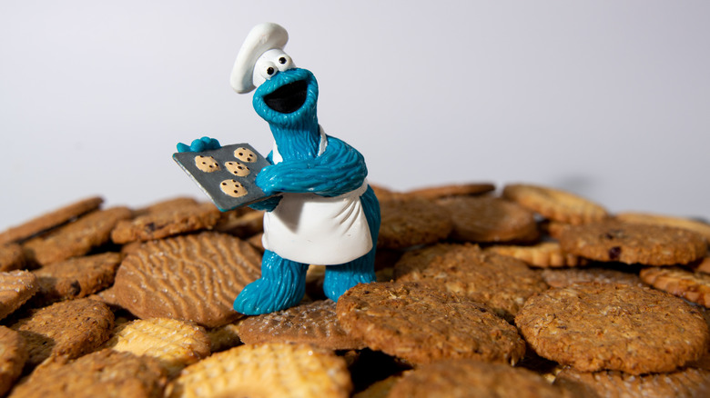 Cookie Monster figurine placed in a batch of freshly baked cookies