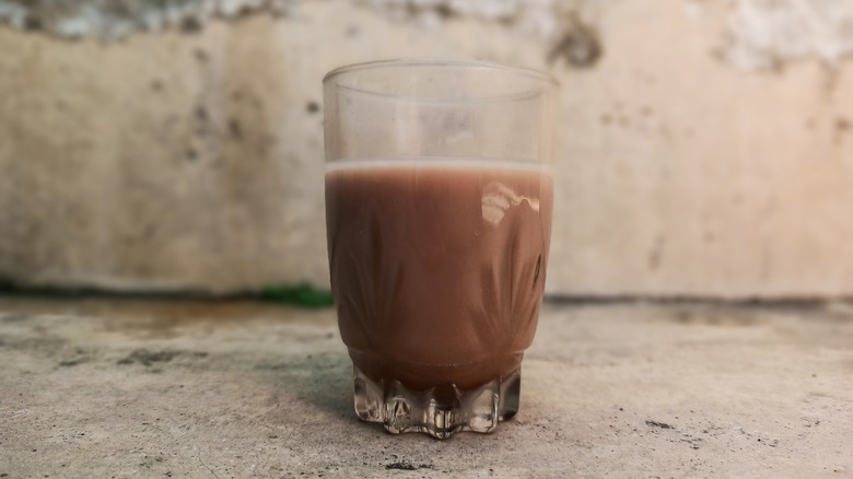 Glass of chocolate milk on a stone ground