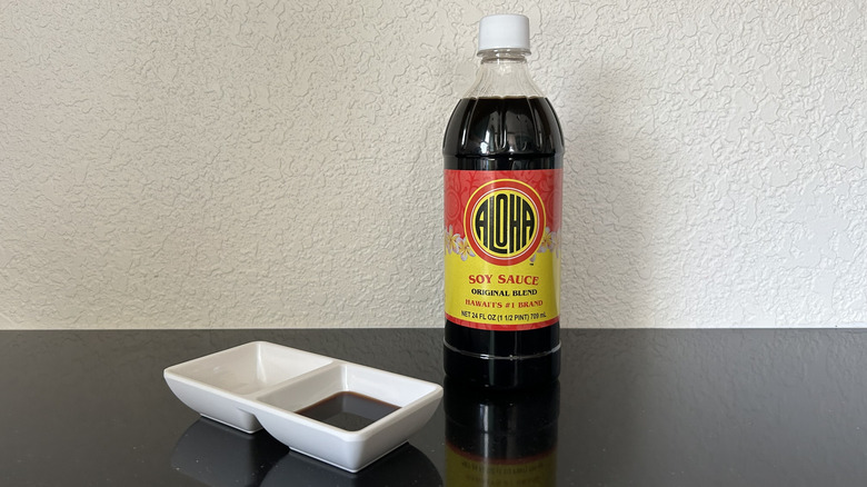 A large bottle of Aloha soy sauce next to a dipping dish