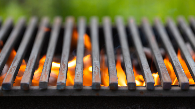 Close-up of grill grates with flame underneath