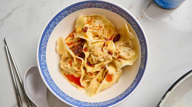 Bowl of spicy wontons on a table