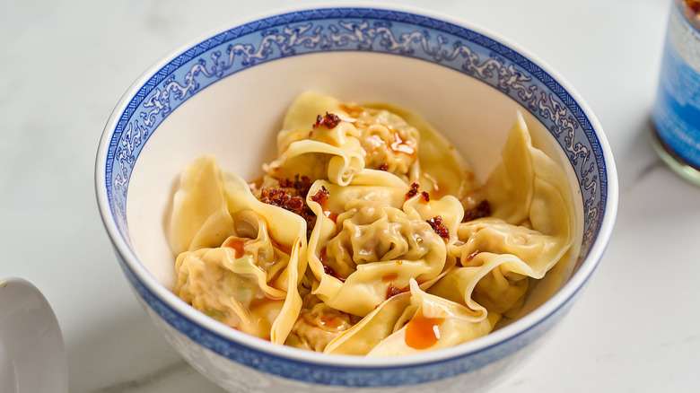 wontons in a bowl with chili oil