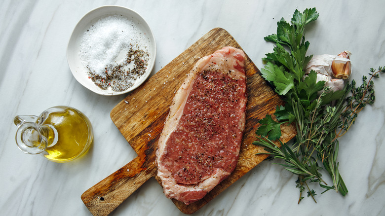 Steak, spices, herbs, garlic, and oil