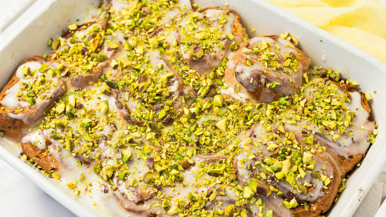 Preserved lemon cinnamon buns in white baking dish.