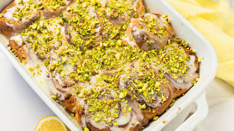 Preserved lemon cinnamon buns in white baking dish.