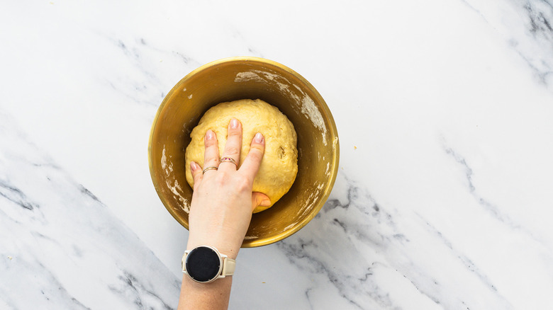 Kneading cinnamon bun dough.