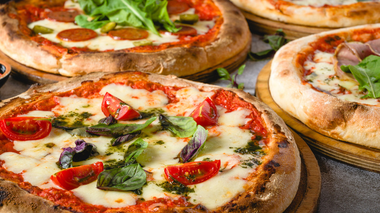 pizzas sitting on pizza stones