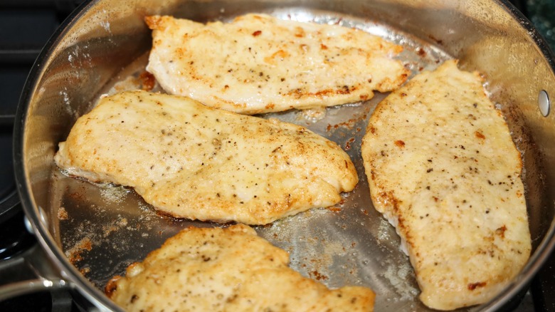 cooking flour dusted chicken
