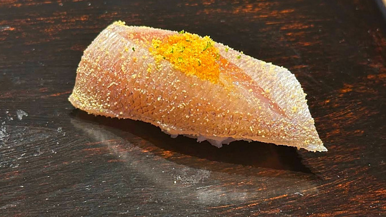 Nigiri roll topped with crumbled egg yolk at Sushi Sho