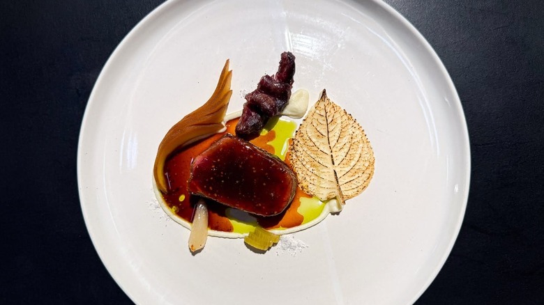 Glazed meat course with a leaf-shaped tuile at Counter-