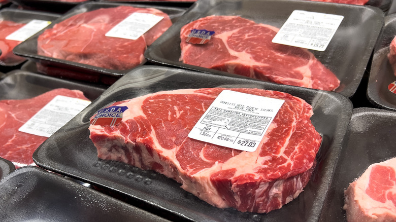 USDA Choice steaks in packaging in grocery store refrigerator