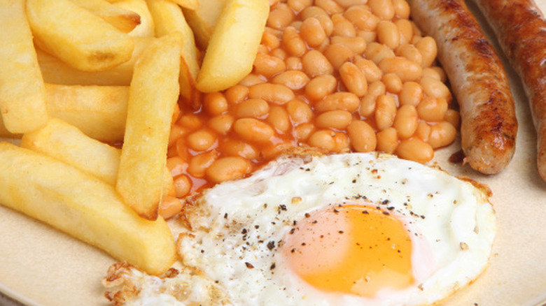 Close-up image of the sausage, egg, chips, and beans dish.