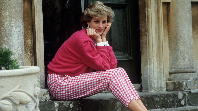 Princess Diana sitting on step with her head in her hands
