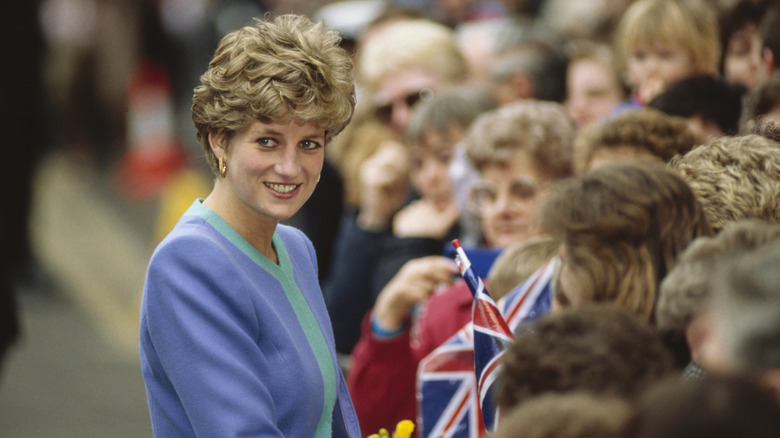 Princess Diana smiles while greeting fans