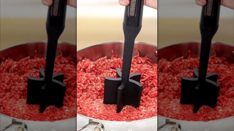 A person breaking up ground beef with a Farberware nylon meat masher