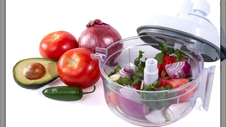 A Salsa Master salsa maker with tomatoes and onions