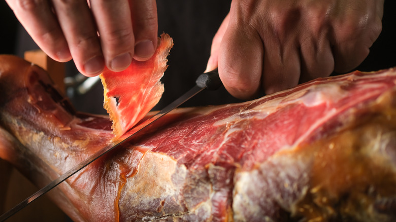 Prosciutto being sliced