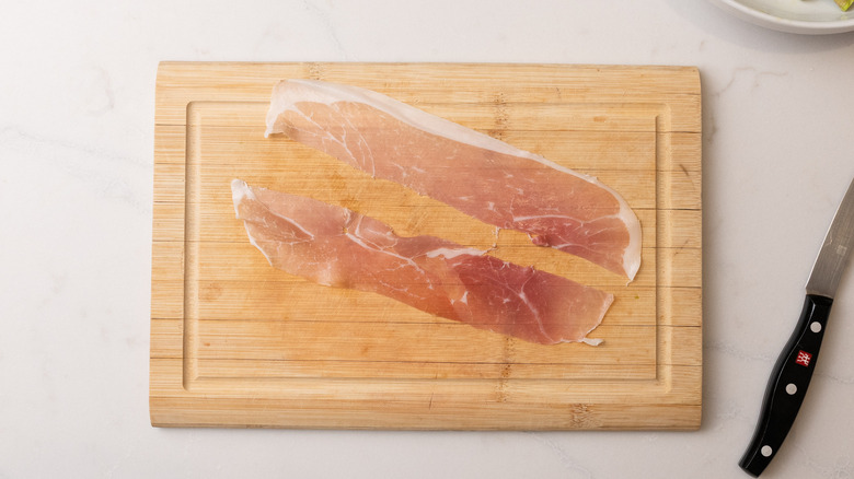 sliced prosciutto on chopping board