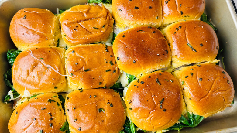 Sliders topped with chives in baking pan