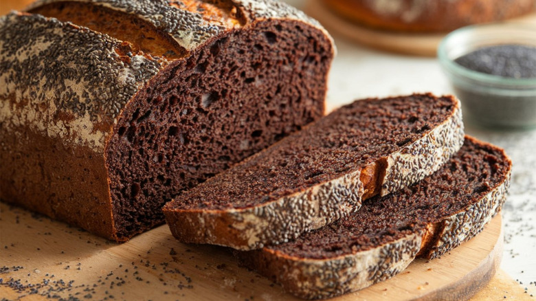 A loaf of slicked pumpernickel bread