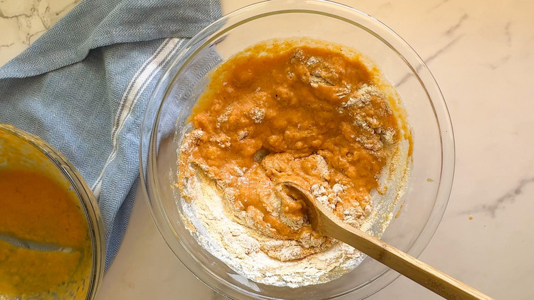 Mixing pumpkin cornbread ingredients in bowl