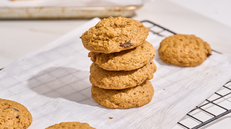 pumpkin cookies stacked on a table
