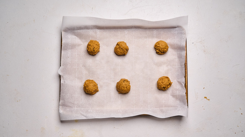dough balls on a parchment lined sheet tray