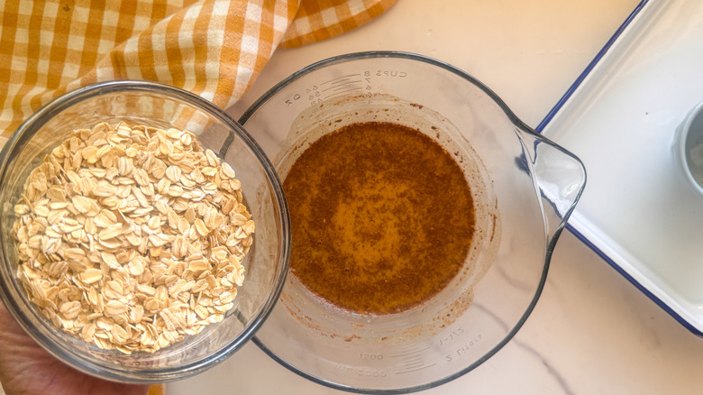 adding oats to bowl
