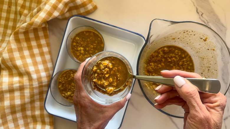 hand scooping mixture into jar