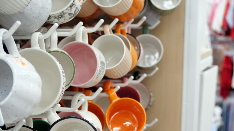 Close-up of rows of hanging mugs