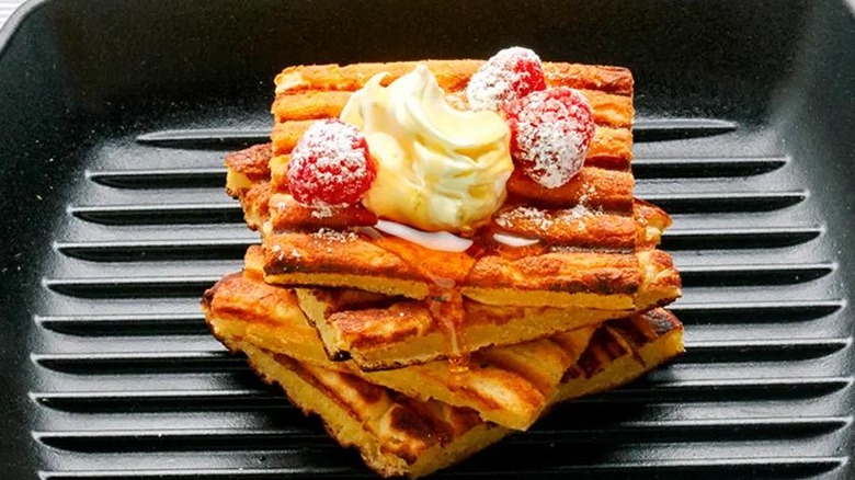 Grill pan waffles on a grill pan with cream and berries