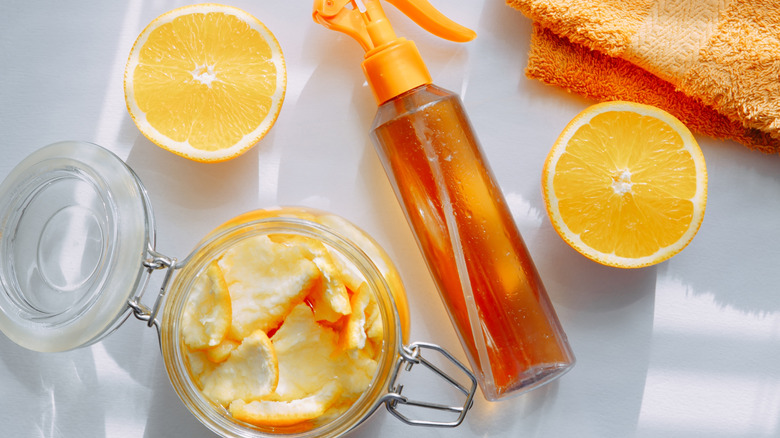 Orange halves, peels in a jar, and spray bottle